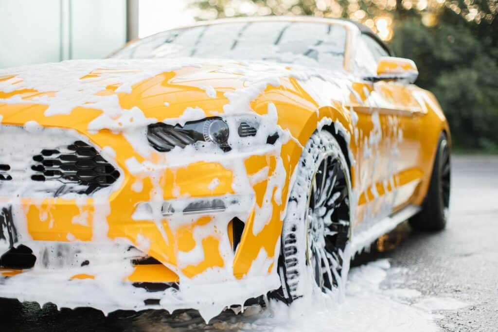 Car in Portsmouth being cleaned using the two bucket wash method, ensuring a thorough and scratch-free wash