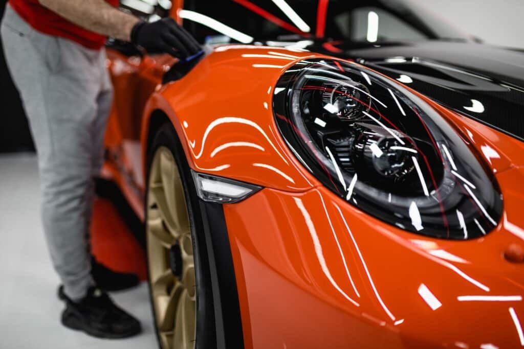 Car in Portsmouth being treated with a clay bar to remove contaminants and achieve a smooth, shiny paint finish