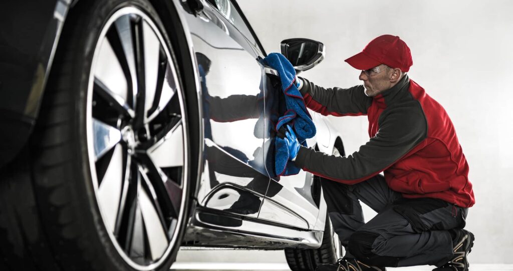 Professional hand car wash service in Portsmouth, detailing a car's exterior for a spotless and polished finish.